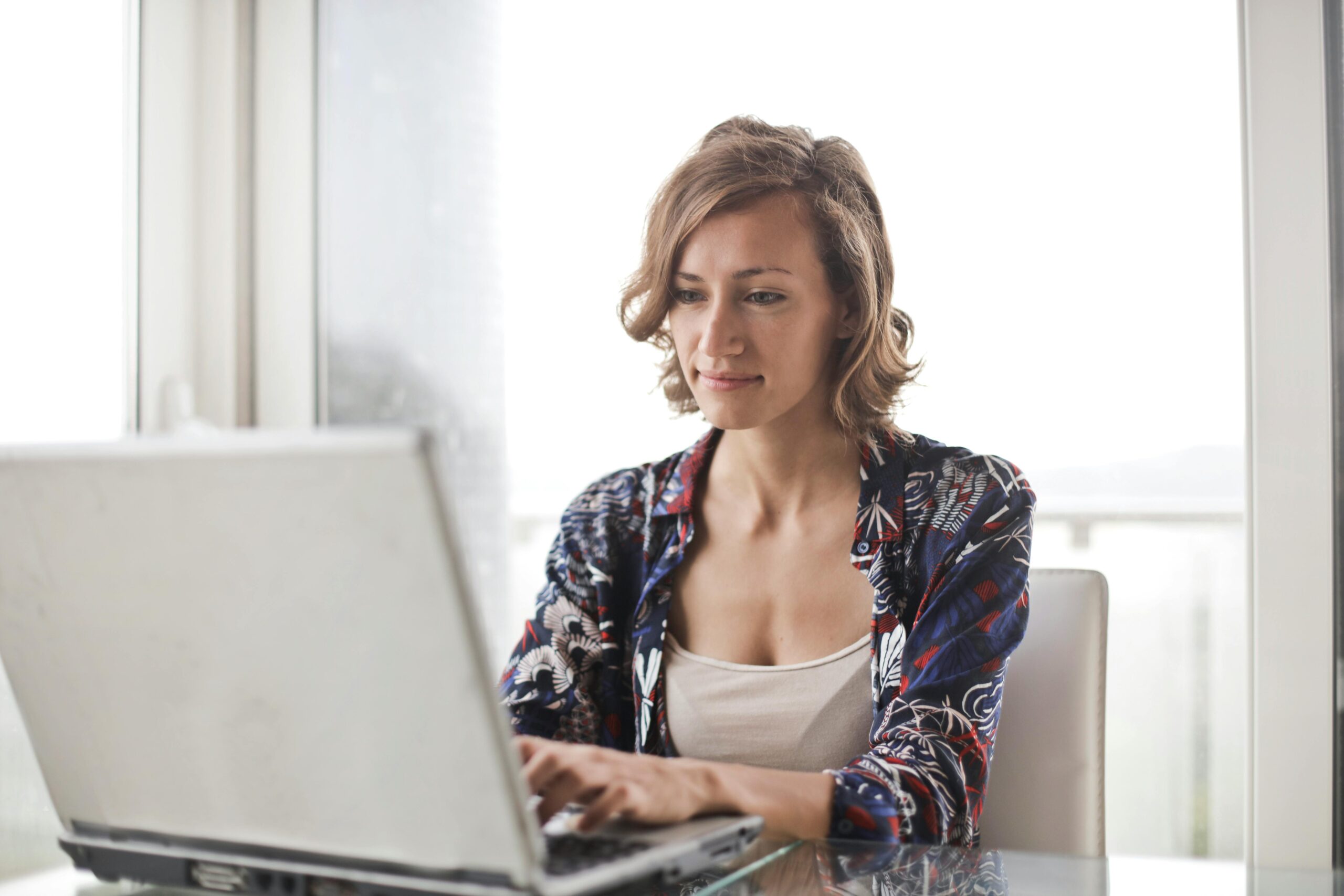 Person sitting and typing at a computer